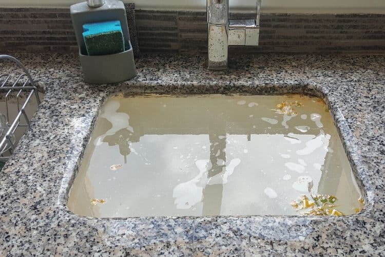 clogged sink drain backing up water