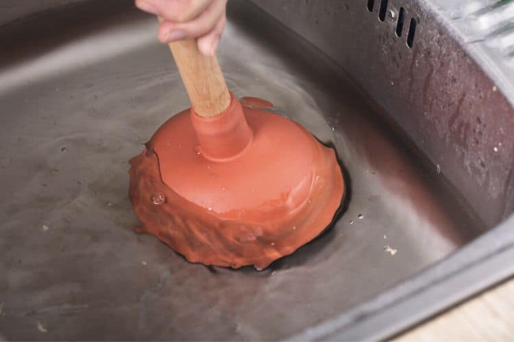 using a plunger in a kitchen sink