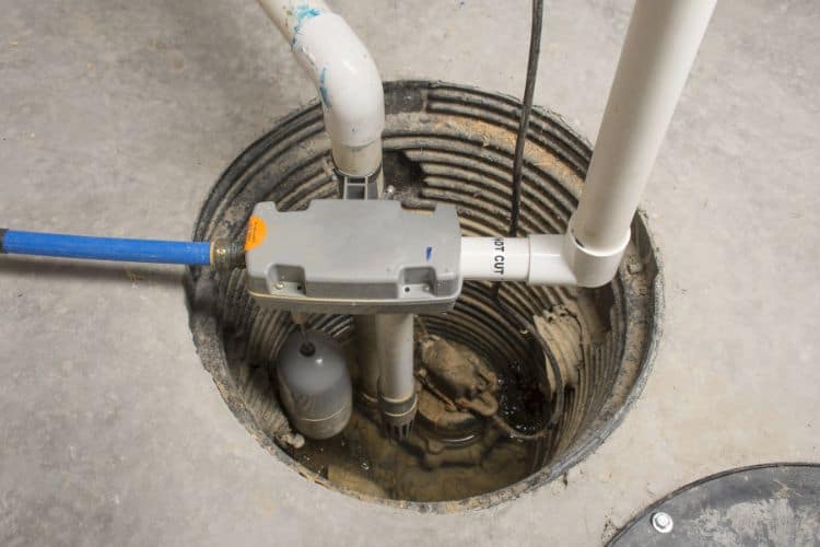 A sump pump installed in a homes basement floor