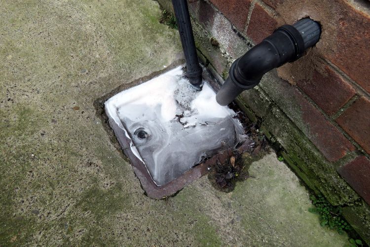 Build up of soapy water coming from the drain pipe leading to external drain