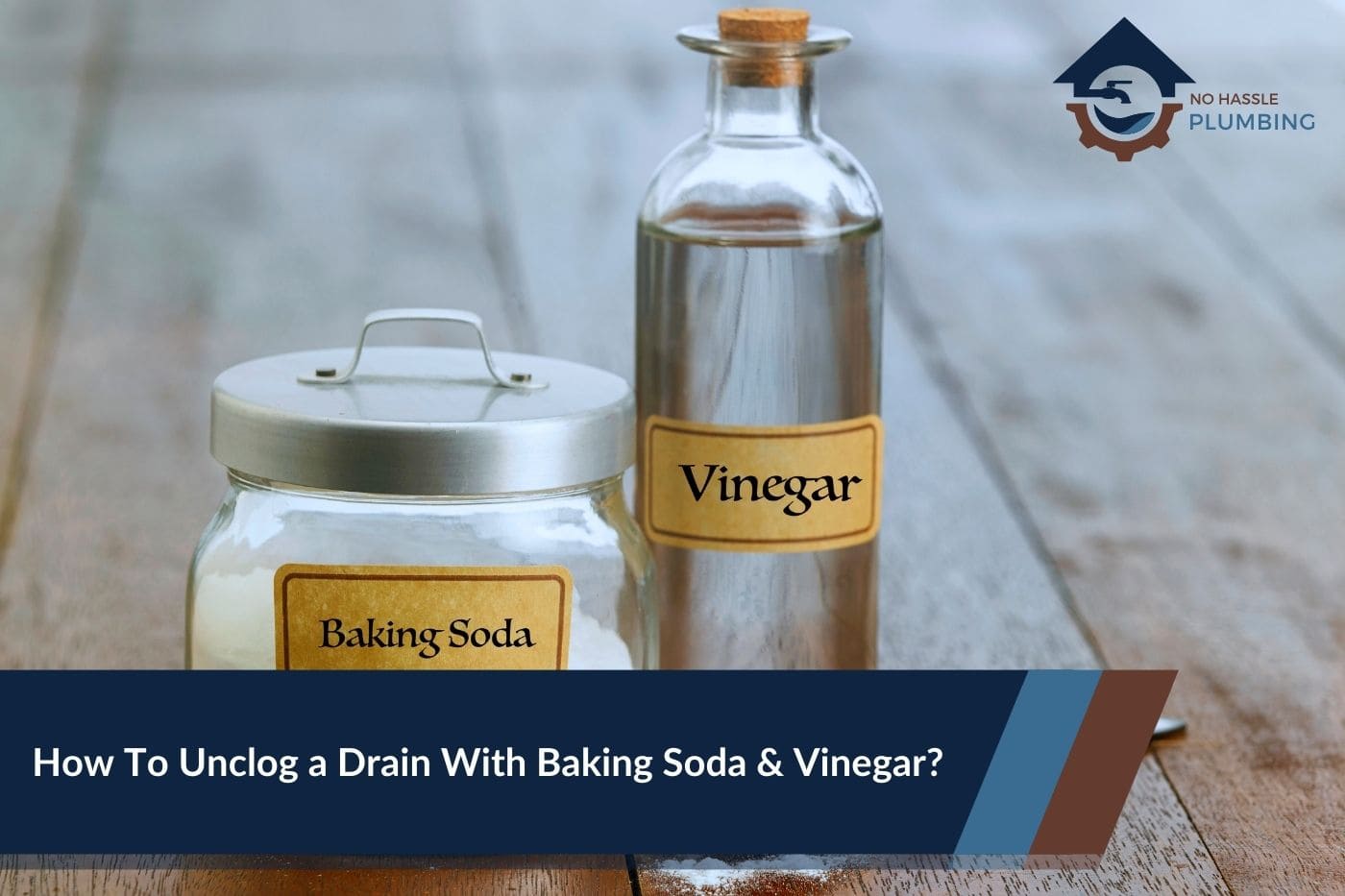 How To Unclog a Drain With Baking Soda & Vinegar - No Hassle Plumbing.com featured image showing a bottle of vinegar and a jar of baking soda