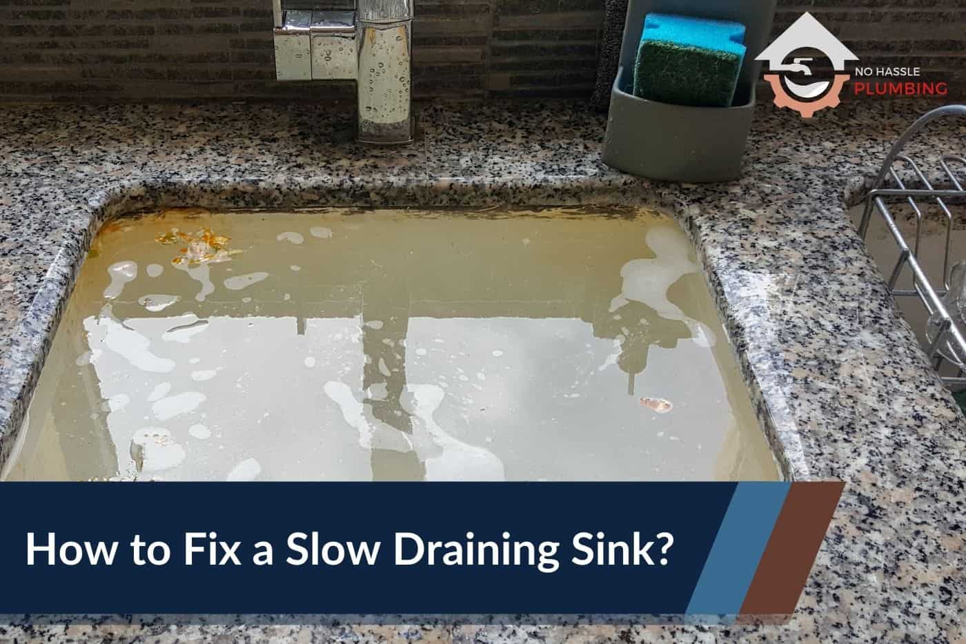 How to Fix a Slow Draining Sink - No Hassle Plumbing.com Feature Image of an kitchen sink full of dirty standing water
